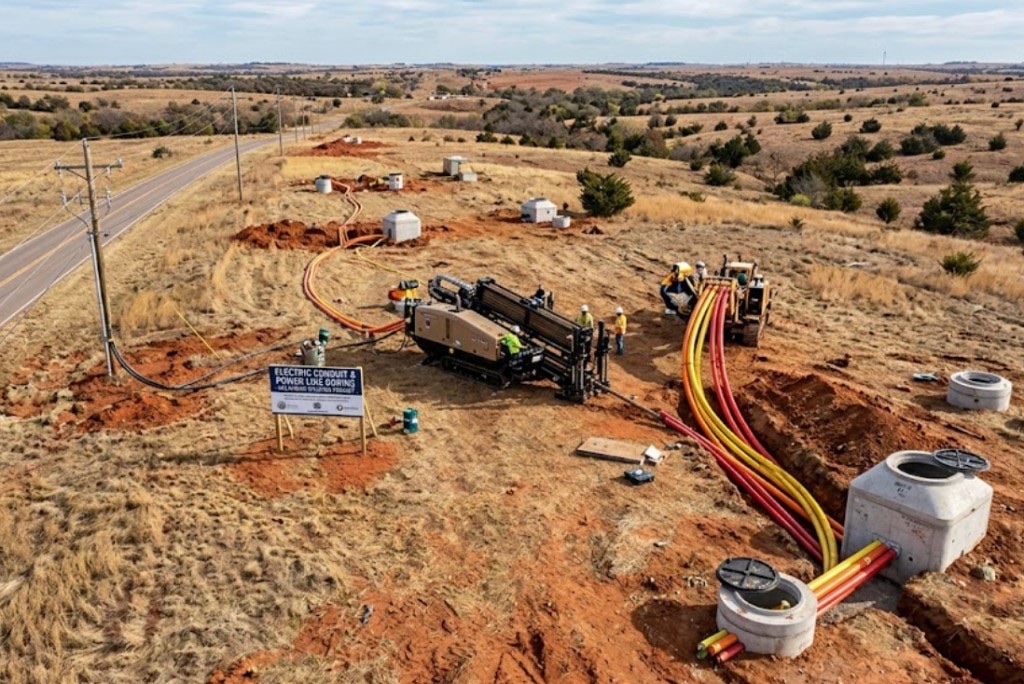 aerial view of HDD rig, vacuum truck, and safety-marked directional boring field site