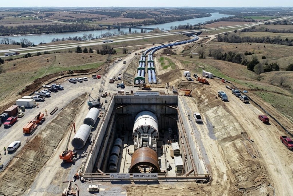 large-scale directional drilling operation with excavators, HDPE pipe, and full crew on Oklahoma job site